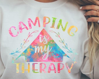 May include: White sweatshirt with a colorful graphic design that says "Camping is my therapy".