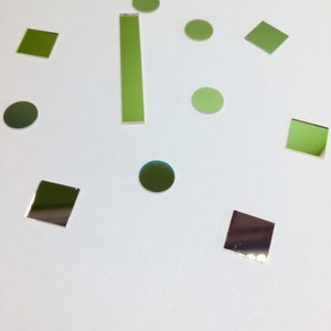 May include: Assortment of green and silver square and round mirror tiles.