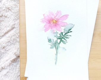 May include: A watercolor painting of a single pink flower with green leaves and stem on a white background.