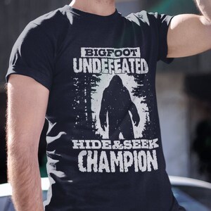 Funny Bigfoot Shirt Undefeated Hide and Seek Champion Sasquatch TShirt Unique Bigfoot Gift Short-Sleeve Unisex Tee T-Shirt