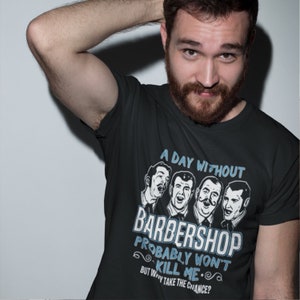 Puede incluir: Una camiseta negra con un diseño gráfico blanco que dice "A day without barbershop probably won't kill me. But why take the chance?" El gráfico presenta cuatro hombres de dibujos animados con bigotes y diferentes peinados.