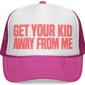 May include: A pink and white trucker hat with the text "GET YOUR KID AWAY FROM ME" in coral letters. The hat features a pink brim and mesh back, with a white front panel.