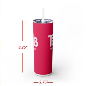 May include: A pink stainless steel tumbler with a white lid and straw. The tumbler is 8.25 inches tall and 2.75 inches wide. It features the words "Tab" and "Never Forget!" in white text.