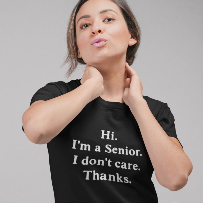 May include: A black t-shirt with white text that reads "Hi. I'm a Senior. I don't care. Thanks."