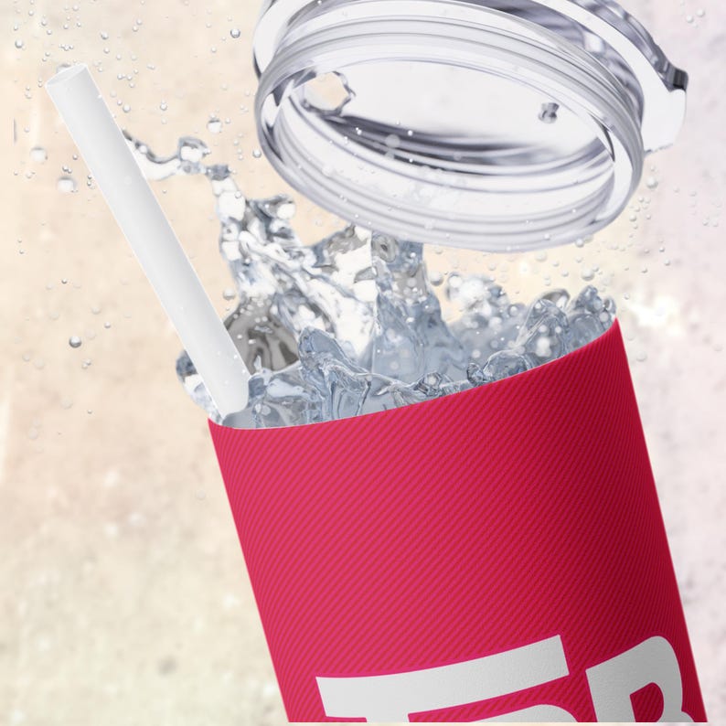 May include: A pink reusable tumbler with a white straw and a clear lid. The tumbler is filled with water and ice.
