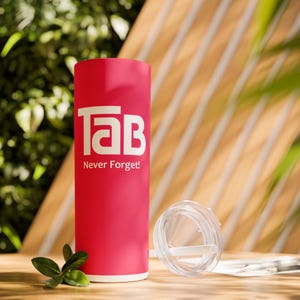 May include: A pink stainless steel tumbler with a white logo that says "Tab Never Forget!"