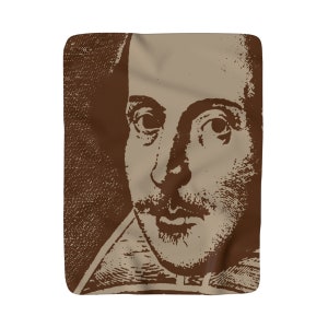 May include: A brown and beige blanket featuring a detailed portrait of William Shakespeare. The image is a close-up of the playwright's face, with a focus on his eyes, mustache, and beard. The blanket has a soft, textured appearance.