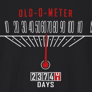 May include: Black graphic design featuring an "OLD-O-METER" gauge with numbers from 10 to 120. A red needle points to the 60 mark. Below, a digital display reads "23744 DAYS".