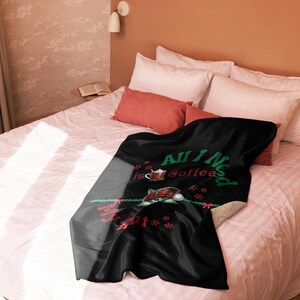 a bed with a blanket and pillows on top of it