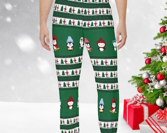 May include: Green pajama pants with a Christmas penguin pattern. The penguins are wearing hats and scarves and are skiing down a snowy hill. The pants have a white and green striped pattern.