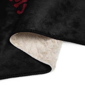 a black and white blanket with red letters on it