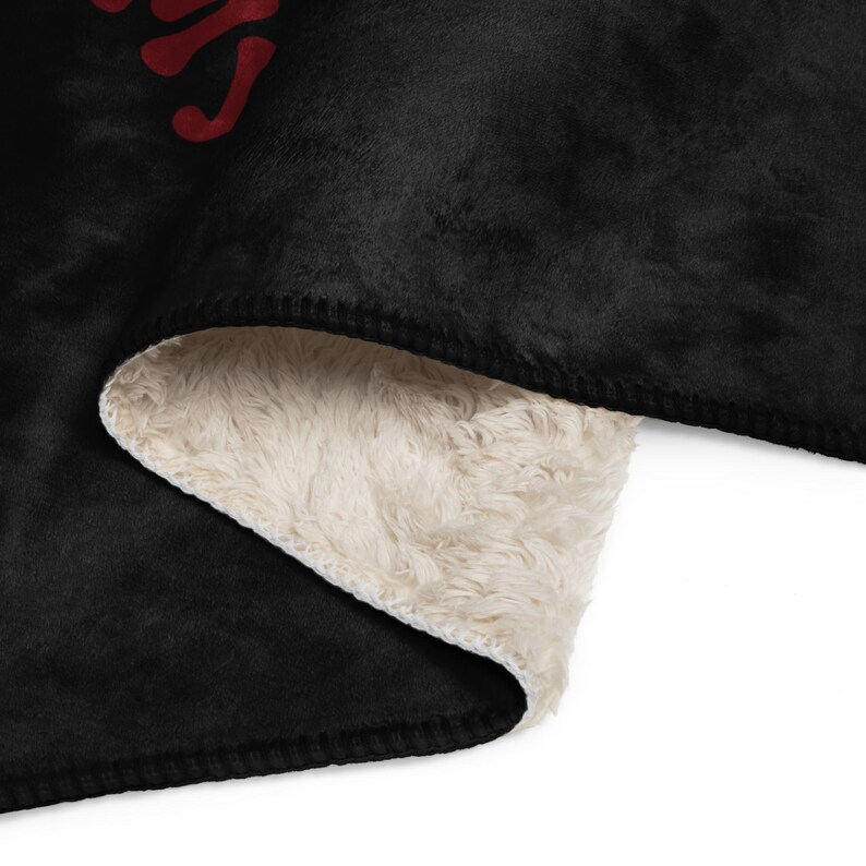 a black and white blanket with red letters on it