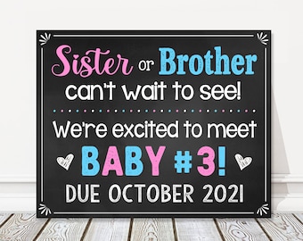 May include: Black chalkboard sign with white text announcing a pregnancy. The text reads "Sister or Brother can't wait to see! We're excited to meet BABY #3! DUE OCTOBER 2021".
