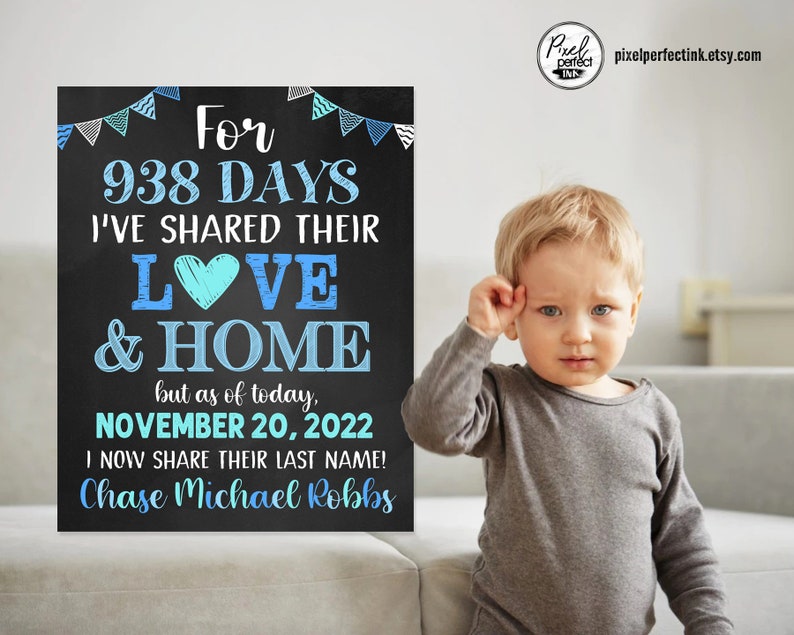 May include: A chalkboard sign with blue and white bunting at the top. The sign reads "For 938 days I've shared their love & home, but as of today, November 20, 2022 I now share their last name! Chase Michael Robbs". A young boy is standing in front of the sign, looking at the camera.