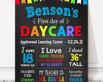 May include: A colorful chalkboard sign announcing Benson's first day of daycare at Applewood Learning Center on 02.24.21. The sign includes details about Benson, such as his age (18 months old), height (36 inches tall), favorite food (chicken), favorite activities (cars, trucks, playing outside, and his blanket), and his teacher's name (Ms. Shayla).