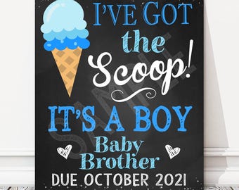 May include: A chalkboard sign with a blue and white ice cream cone graphic. The text reads "I've got the scoop! It's a boy. Baby Brother. Due October 2021."