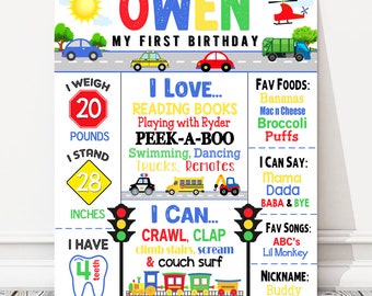 May include: A colorful first birthday chart for a boy named Owen. The chart features a car theme with illustrations of cars, trucks, and a helicopter. It includes details like weight, height, favorite foods, and things the child can do.