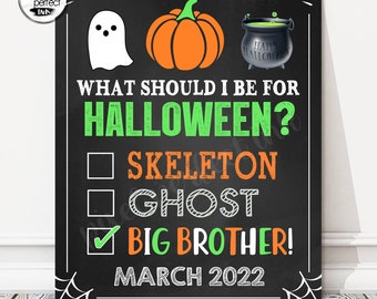 May include: A Halloween-themed sign on a black background with a white ghost, orange pumpkin, and cauldron. Text reads "WHAT SHOULD I BE FOR HALLOWEEN?" with options for Skeleton, Ghost, and Big Brother, marked with a check. The sign also includes "MARCH 2022".