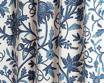 May include: A white fabric with a blue floral pattern. The pattern features intricate designs of leaves, flowers, and vines.