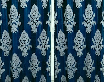 May include: Two teal blue velvet curtains with a white damask pattern.
