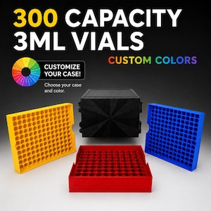 May include: A black storage case with a geometric lid, accompanied by three removable trays in yellow, red, and blue. Each tray features a grid of circular slots designed for 300 capacity 3ml vials. Text reads 300 CAPACITY 3ML VIALS CUSTOM COLORS.