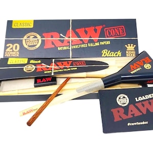 May include: A pack of 20 RAW Black King Size Cone rolling papers with a RAW cone loader. The box is black with red and white text. The loader is black with red text and a RAW logo.