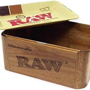 May include: A wooden box with a removable tray. The box is made of a light brown wood and has the word "RAW" engraved on the front. The tray is yellow with the "RAW" logo and text.