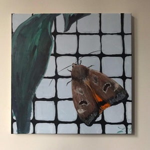 May include: A painting of a brown moth with orange markings on its wings, perched on a white tiled surface with black grout. A green leaf is partially visible in the background.