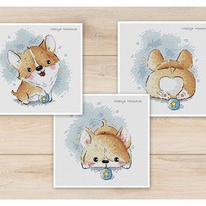May include: Three cross-stitch patterns featuring a cute cartoon corgi dog playing with a blue ball. The corgi is brown and white with a pink nose and tongue. The patterns are on a light blue background with white stars.