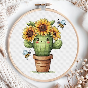 May include: A cute cartoon cactus with a smiling face wearing a crown of yellow sunflowers. Two yellow and black bees are flying around the cactus, which is potted in a brown pot.