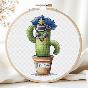 May include: A green cactus wearing a blue police hat with a gold star, sunglasses, and a smile. The cactus is in a brown pot with the word "Police" written on it.