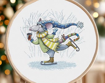 May include: A cross-stitch pattern of a mouse wearing a blue hat and scarf, ice skating and holding a cup of coffee. The mouse is on a white background with a blue and white winter scene.