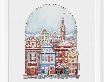 May include: A cross-stitch pattern of a snowy European village with a tall church steeple and string lights overhead. The buildings are decorated with red, green, and white accents. The pattern is perfect for a winter holiday project.