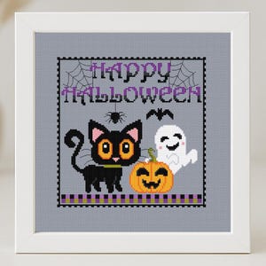 May include: A cross-stitch pattern featuring a black cat, a ghost, and a pumpkin with the text "Happy Halloween".