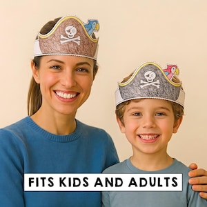 May include: Two paper pirate hats featuring a skull and crossbones design with a colorful parrot accent. The hats are colored with brown and grey pencil textures and include the text FITS KIDS AND ADULTS printed on a white rectangular banner.