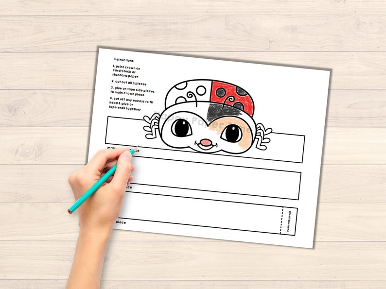 May include: Printable ladybug headband craft template. The template includes a black and white ladybug head with red and black wings, and instructions for assembly.