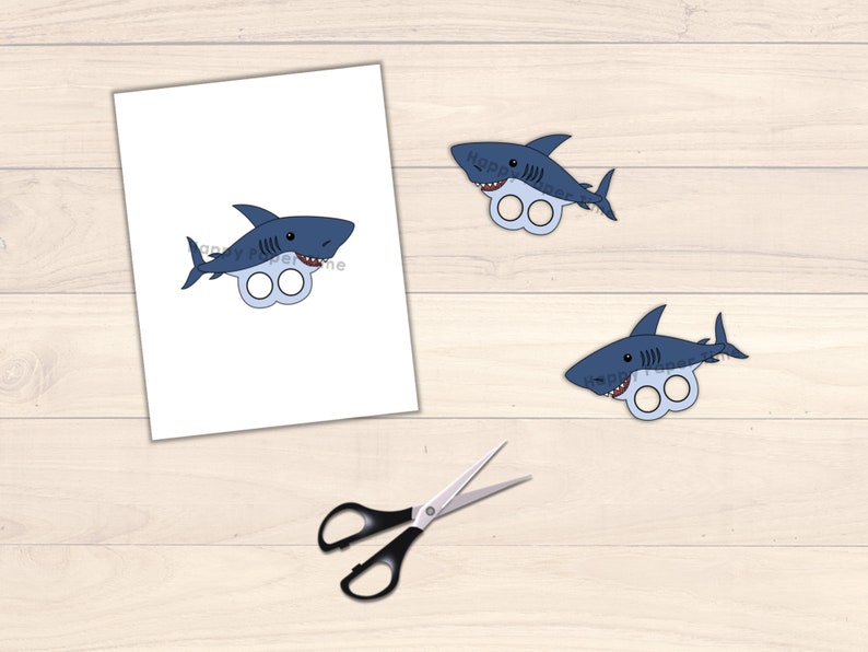 May include: Printable shark finger puppets. Two blue shark finger puppets with white teeth and eyes. The sharks have two holes for fingers.