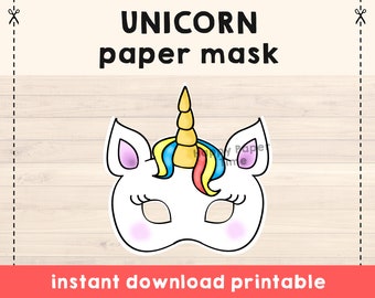 Puede incluir: Máscara de papel de unicornio imprimible. La máscara es blanca con una nariz rosa, un cuerno azul y amarillo y pestañas negras. El texto "descarga instantánea imprimible" está en la parte inferior de la imagen.