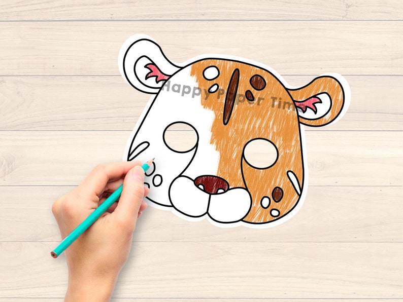 May include: A printable paper mask of a tiger with orange and white fur. The mask has cutouts for the eyes and is ready to be coloured in.
