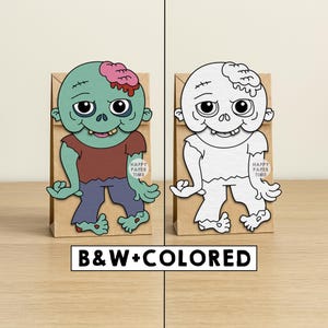 Peut inclure: Deux sacs cadeaux en papier, un en couleur et un en noir et blanc, chacun avec un motif de personnage de zombie. Le zombie en couleur a une t&ecirc;te verte, une chemise rouge et un pantalon bleu. Les sacs portent le texte "HAPPY PAPER TIME".