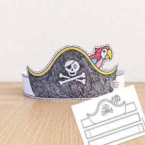 May include: A paper pirate hat craft featuring a black skull and crossbones design with a colourful parrot accent. The hat is coloured with black, yellow, red, and blue markers. A flat, uncoloured paper template with the same design is also visible.