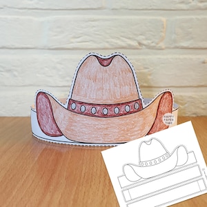 Könnte beinhalten: Ein Cowboyhut-Bastelprojekt aus Papier, bestehend aus einem braunen Hut mit einem dunkelroten Band und silbernen kreisförmigen Akzenten. Der Hut hat eine gestrichelte Schnittlinie und enthält ein separates, flach bedrucktes Vorlagenblatt.