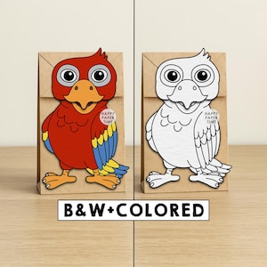 May include: Two brown paper bags featuring a parrot cutout. The left bag displays a red, blue, and yellow parrot, while the right bag shows a black and white outline of the same parrot. Each bag has a small circular sticker reading HAPPY PAPER TIME.