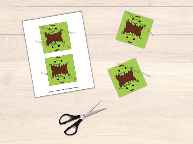 May include: Printable Frankenstein monster craft for kids. The craft is made of green paper with brown hair and a stitched mouth. The craft is folded in half and has a happy face on each side.