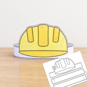 May include: A yellow paper construction hat craft project with a dashed cutting line along the edge. Beside it lies a flat, white paper template featuring the same hat design and the text Happy Paper Time, ready to be cut out and assembled.