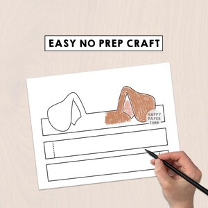 May include: A printable craft sheet featuring a dog ear headband template with the text EASY NO PREP CRAFT at the top. One set of ears is outlined in black, while the other is colored in brown with pink inner details. A circular logo reads HAPPY PAPER TIME.
