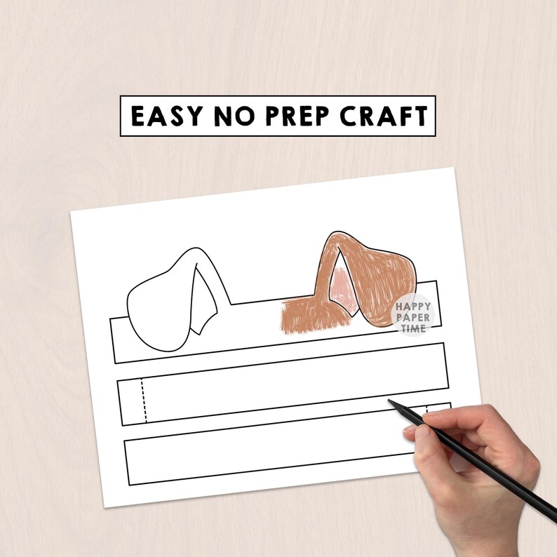 May include: A printable craft sheet featuring a dog ear headband template with the text EASY NO PREP CRAFT at the top. One set of ears is outlined in black, while the other is colored in brown with pink inner details. A circular logo reads HAPPY PAPER TIME.