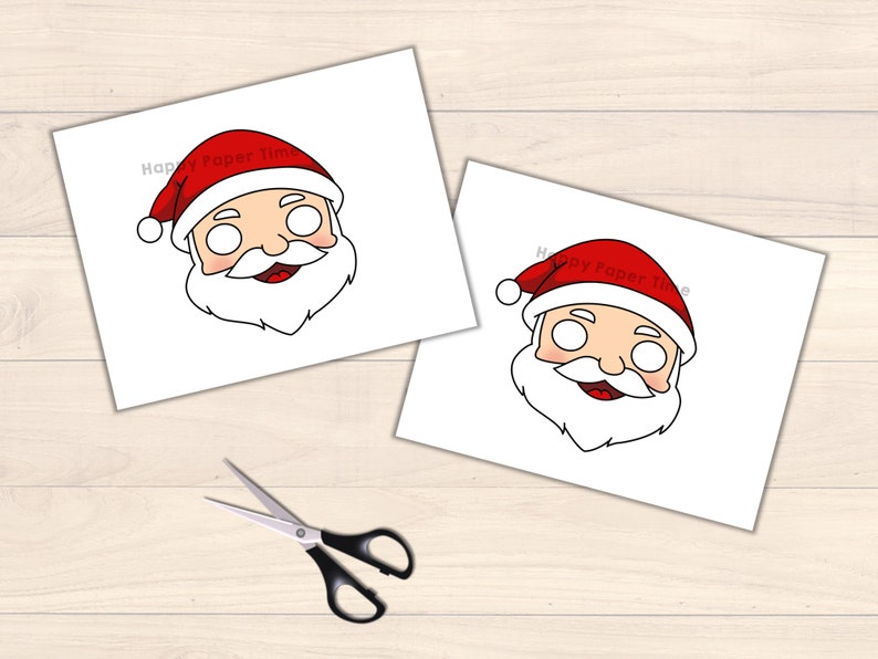 May include: Two Santa Claus face masks printed on white paper, featuring red hats and white beards. The text "Happy Paper Time" is printed on the top of the masks. A pair of scissors with black handles and silver blades is also in the image.