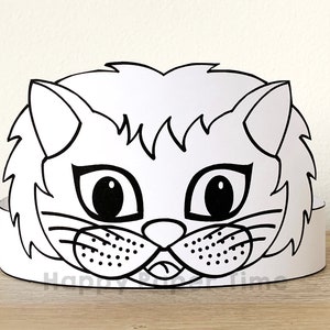 May include: Black and white printable cat mask craft. The mask features a cat face with large eyes, a nose, whiskers, and a mouth. The mask is designed to be cut out and worn as a headband.