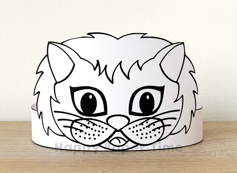 May include: Black and white printable cat mask craft. The mask features a cat face with large eyes, a nose, whiskers, and a mouth. The mask is designed to be cut out and worn as a headband.